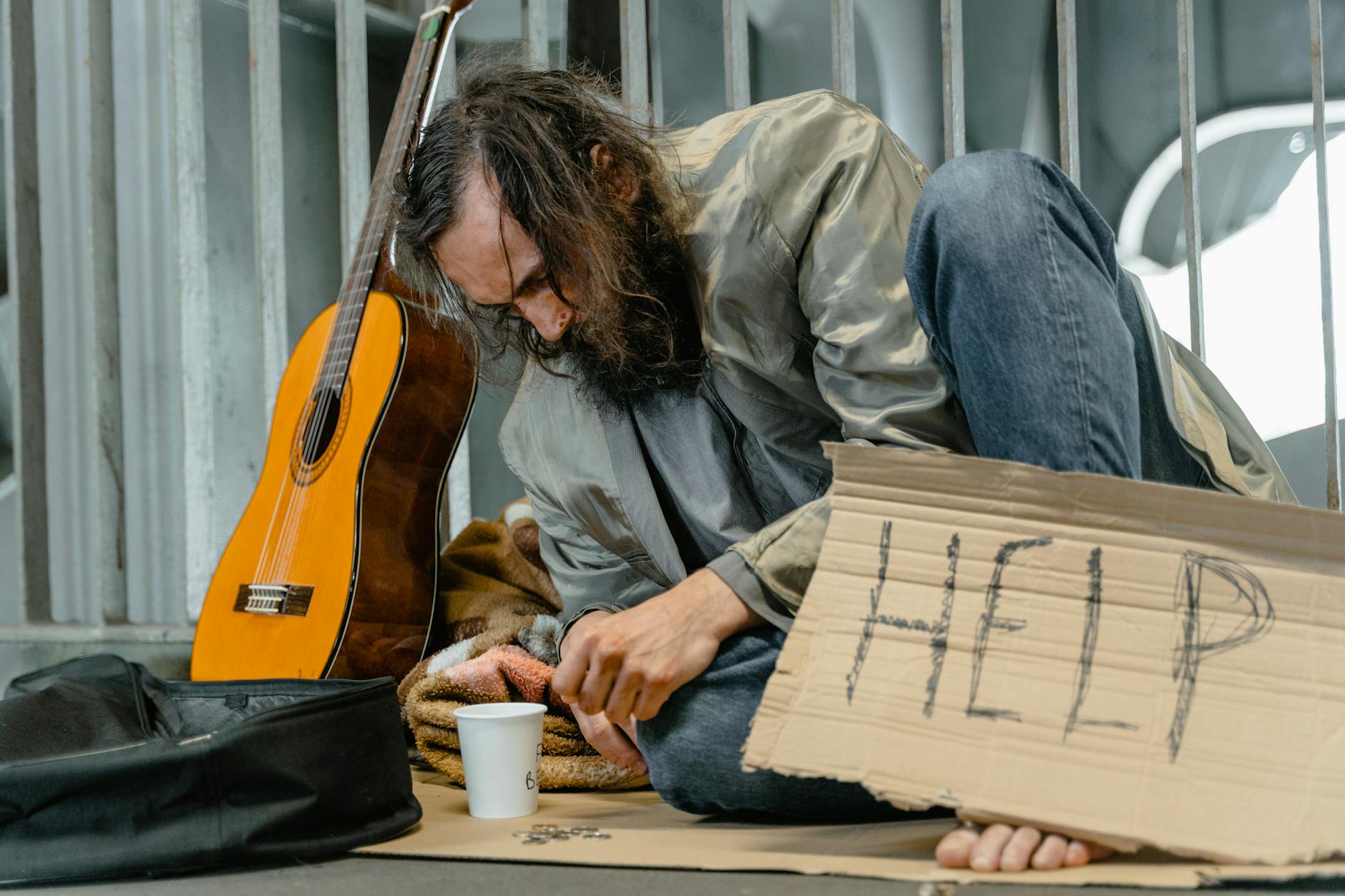 bearded man sitting on the ground