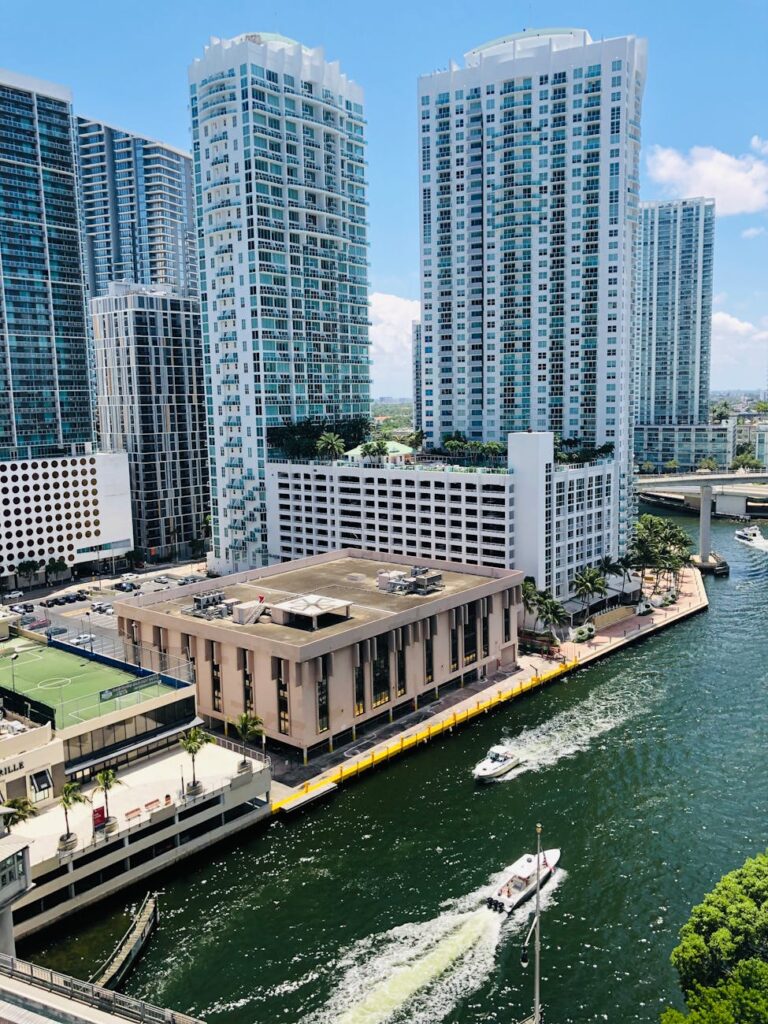photo of motorboats on river near buildings